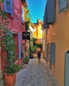 a person walking down an alley way in the city