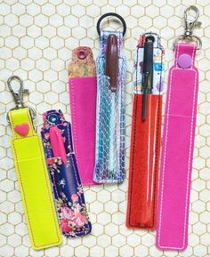 four pens and pencils are lined up next to each other on a table top