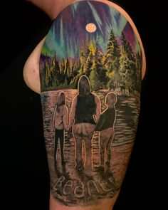 the back of a man's arm with an image of three people on it