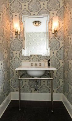 a white sink sitting under a bathroom mirror next to a wall mounted faucet