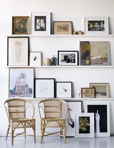 an instagram photo with two chairs and pictures on the wall