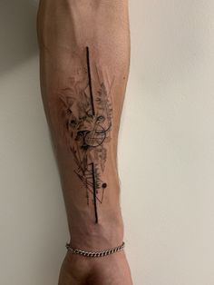 a man's arm with a tattoo on it that has an abstract design and lines