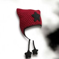 a crocheted red hat with black stars on it