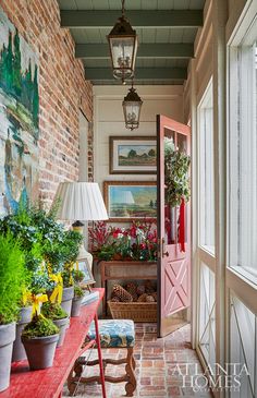 the inside of a house with plants on the porch and potted plants in pots