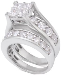 a white gold wedding ring set with two princess cut diamonds on each band and an oval shaped diamond in the center