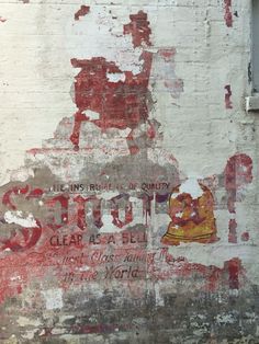 an old sign painted on the side of a building