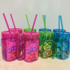 there are many different colored mason jars with straws in them and one is filled with koolies