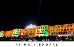 an illuminated building with the words aims bhopal on it