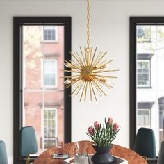 a dining room table with chairs and a chandelier hanging from the ceiling