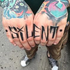 two hands that have some writing on them and one has the word evil written in black ink