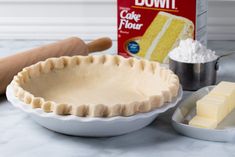 a pie crust, butter and other ingredients on a counter