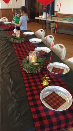 a long table with plates and balloons on it