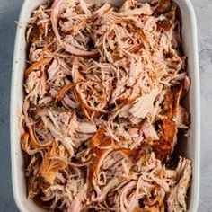 shredded meat in a casserole dish on a table