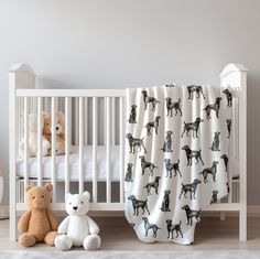 a baby crib with two stuffed animals next to it