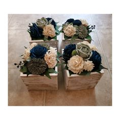 four wooden boxes filled with flowers on top of a tiled floor