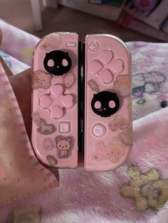 a pink cell phone with hello kitty buttons on it