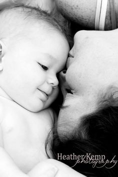 a black and white photo of a woman holding a baby in her arms with the caption, healther kemp photography