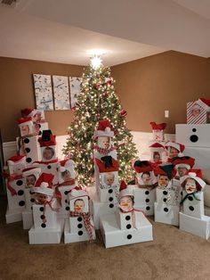 a christmas tree is decorated with snowmen and presents