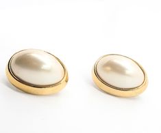 Trifari signed cream faux pearl cabochon gold toned clip on vintage earrings. Good vintage condition with little to no signs of normal vintage wear. Stamped Trifari on the back of the earrings and on the clip fastening. Earrings measure 1 inch tall and 3/4ths of an inch wide. Formal Cream Pearl Earrings, Vintage Formal Clip-on Cabochon Earrings, Vintage Pearl Clip-on Earrings, Vintage Pearl Clip-on Earrings For Gift, Vintage Trifari Earrings, Vintage Yellow Gold Cabochon Clip-on Earrings, Vintage Wear, Vintage Earrings, Clip On