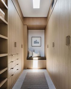 an empty hallway leading to a bedroom with built - in bookshelves and drawers