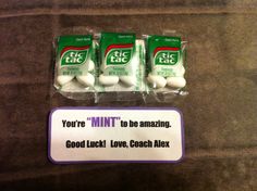 three packets of mints sitting on top of a counter next to a sign that says, you're mintt to be amazing good luck love coach alex