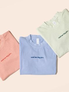 three t - shirts with words on them sitting next to each other in different colors