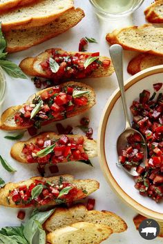 a table topped with slices of bread covered in salsa