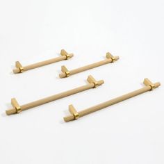 four brass door handles on a white background