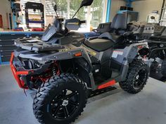 an atv is parked in a garage with other vehicles