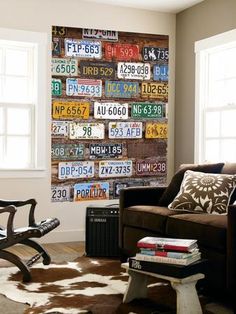 a living room filled with furniture and a cow rug on top of a hard wood floor