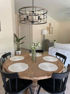 a wooden table with black chairs around it