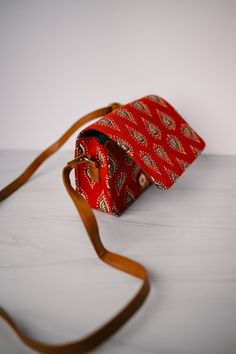 This box sling bag is perfect for carrying just the essentials, in style. Details: -7"L x 3"W x 5.25"H -Made with a Indian cotton fabric -magnetic, snap close front flap -vegan leather, cognac colored, adjustable strap (up to 42") -Lined interior -1 interior pocket Small Sling Bag, Indian Prints, Indian Cotton, Sling Bag, Cognac, In Style, Vegan Leather, Adjustable Straps, Cotton Fabric