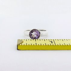 "A sterling silver ring with a gorgeous bright purple faceted amethyst. Available in US ring sizes 6-8. The natural amethyst gemstone is 8mm (3/8\" inch). Please message me if you would like a size not listed. Custom orders are welcome!" Amethyst Ring With Round Stone, Amethyst Ring With Center Round Stone, Amethyst Ring With Round Center Stone, Faceted Amethyst Ring In Purple, Faceted Amethyst Ring Gift, Purple Faceted Sterling Silver Rings, Faceted Amethyst Purple Ring, Faceted Amethyst Ring In Sterling Silver For Anniversary, Amethyst Ring With Bezel Setting