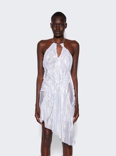 "This Di Petsa dress is intricately draped and sewn by hand, creating an ethereal illusion of water rippling across the body. The dress is draped from a jewelry chain along the neck and cascades into an asymmetrical hem. It is made of 97% recycled polyamide and 3% lurex. Care instructions are provided on the label. The dress has an asymmetrical hem and measures approximately 5'9\"/175cm." Wet Look Dress, Water Ripples, Jewelry Chain, Wet Look, Silver Dress, Asymmetrical Hem, Chains Jewelry, Asymmetric Hem, Care Instructions