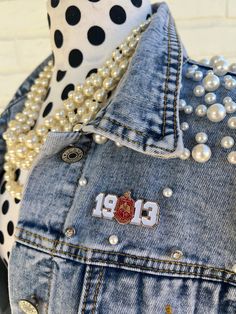 the back of a jean jacket with pearls and polka dots on it, next to a polka dot scarf