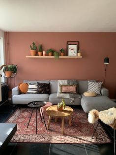 a living room filled with furniture and potted plants