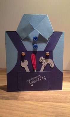 an origami style card with scissors in it