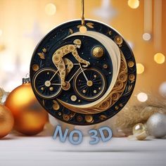 a christmas ornament with a gold and black bicycle on it's side