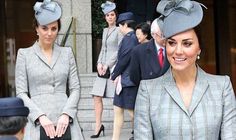 two women in suits and hats walking down the street with other people standing behind them