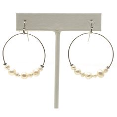 If you are looking for a pair of pearl earrings that showcase this seasons most popular silhouette, these freshwater pearl hoop earrings are a perfect pick. With a trendy style that is here to stay, these June birthstone earrings will stand out. These pearl dangle earrings are this seasons must have fashionable accent. Length: 2 inches Width: 1 3/8 inches Drop: 1 1/2 inches Closure: Hook Weight: 0.2 oz Hypo Allergenic Nickel free and lead free Shipped within 1 business day Our dangle earrings fo Adjustable Hoop Pearl Drop Earrings, Freshwater Pearl Earrings Silver, Bridesmaid Pearl Earrings, Delicate Wedding, Costume Fashion, Freshwater Pearl Earrings, Pearl Dangle Earrings, Birthstone Earrings, Earrings Bridesmaid