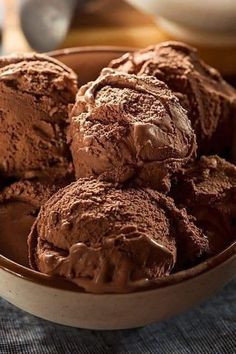 a bowl filled with chocolate ice cream on top of a table