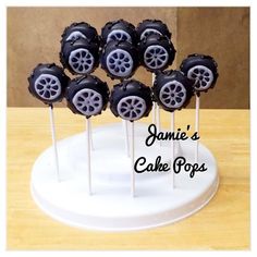 there are some cake pops that have wheels on them, and the words annie's cake pops written in black