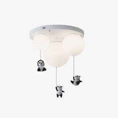 three pandas are hanging from the ceiling with lights on them, and one is in the air