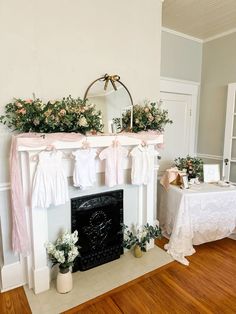 a room with a fireplace decorated for a wedding