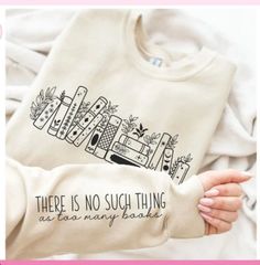 An awesome long sleeved crew neck sweatshirt(NO hood) with a cute graphic of books on a shelf on the center front and the words "THERE'S NO SUCH THING AS TOO MANY BOOKS" on the the left sleeve.  Design/print is black as shown.  Please keep the design color in mind when choosing your shirt color.  YOU CHOOSE YOUR SHIRT COLOR AND SIZE.  Printed on a Gildan 50/50 sweatshirt(or similar) that fits true to size with little to no shrinkage.  Available in adult unisex size S-5X(some colors only available up to 3X - if you choose one of those in a 4 or 5X I will contact you for an alternate color) Cute Bookworm Outfits, Book Outfit Aesthetic, Book Shirt Ideas, Book Sweatshirts, Books On A Shelf, Bookish Style, Book Clothes, Crewneck Design, Avid Reader