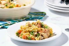 a white bowl filled with pasta and vegetables