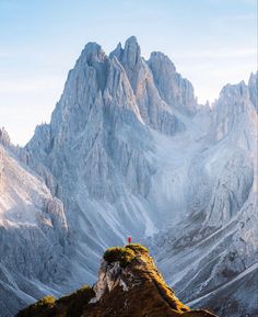 the mountains are covered in snow and grass