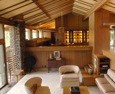 a living room filled with furniture and lots of windows