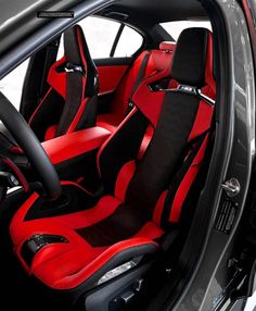 the interior of a sports car with red and black leather upholsters on it