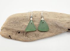 This set of unique earrings is crafted out of genuine sage green sea glass, metallic crystals, silver anti-tarnish wire, and sterling silver earring hooks.   The earrings are 2 inches from the top of the hook to the bottom of the sea glass.  Due to the fact that no two pieces of sea glass are exactly the same, the earrings don't completely match.  These earrings can be worn for any occasion.  They come in a box and are ready to gift. Sea Glass Green, Sea Glass Earrings, Green Sea, Earring Hooks, Silver Earring, Glass Earrings, Unique Earrings, Earring Gifts, Crystal Earrings